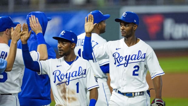 May 19, 2021; Kansas City, Missouri, USA; Kansas City Royals center fielder Michael Taylor (2) and right fielder Jarrod Dyson (1) celebrate with teammates after defeating the Milwaukee Brewers at Kauffman Stadium. Mandatory Credit: Jay Biggerstaff-USA TODAY Sports
